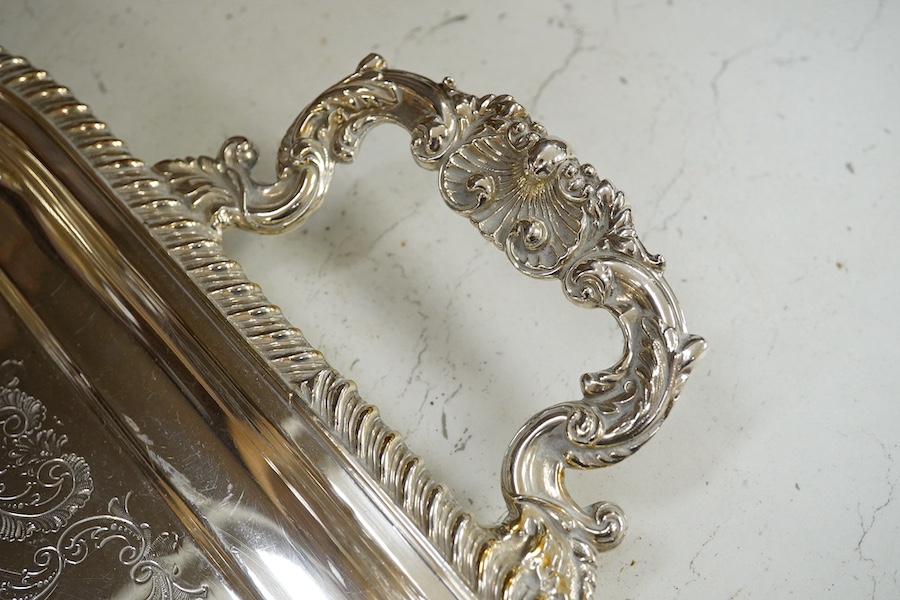 A two handled silver plated tea tray, 63.5cm wide. Condition - some scratches.